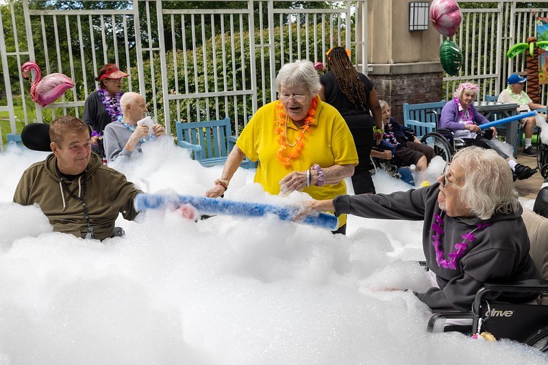 Residents at the Menlo Park Veterans Home enjoy a foam machine at the home's end-of-summer celebration.
